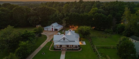 A large house with a spacious front yard, a driveway, and a well-maintained lawn.