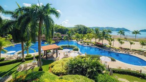 A resort with multiple swimming pools, palm trees, and a beach view. - Veranda 1H -  3 bdr 3 bath Family (Playa Herradura)