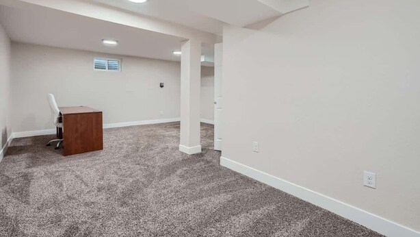 A room with a carpeted floor, a wooden desk, white walls, and recessed ceiling lights. - Charming I Family Friendly I 4bd 2ba Arvada Home (Arvada)