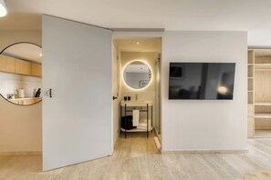 A modern bathroom with a round mirror, a sink, and a toilet. - Modern King Studio in Central Roma Norte (Ciudad de México)
