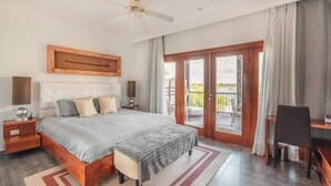 A bedroom with a large bed, a desk, a chair, and a balcony with a view. - Studio 3 guests Balcony with views Fishing lodge 1090 (Punta Cana)