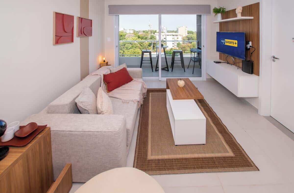 A modern living room with a sofa, coffee table, and TV.