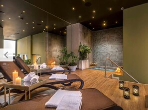 A spa area with massage chairs, candles, and a small pool. - High-Floor City Base 200Mbps Gym, Pool & Sauna (Asunción)