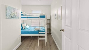 A room with bunk beds, a door, and a window. - Hot Tub, Pet Friendly, 4Bdr 2Bth, - Aqua Vista (Bolivar Peninsula)