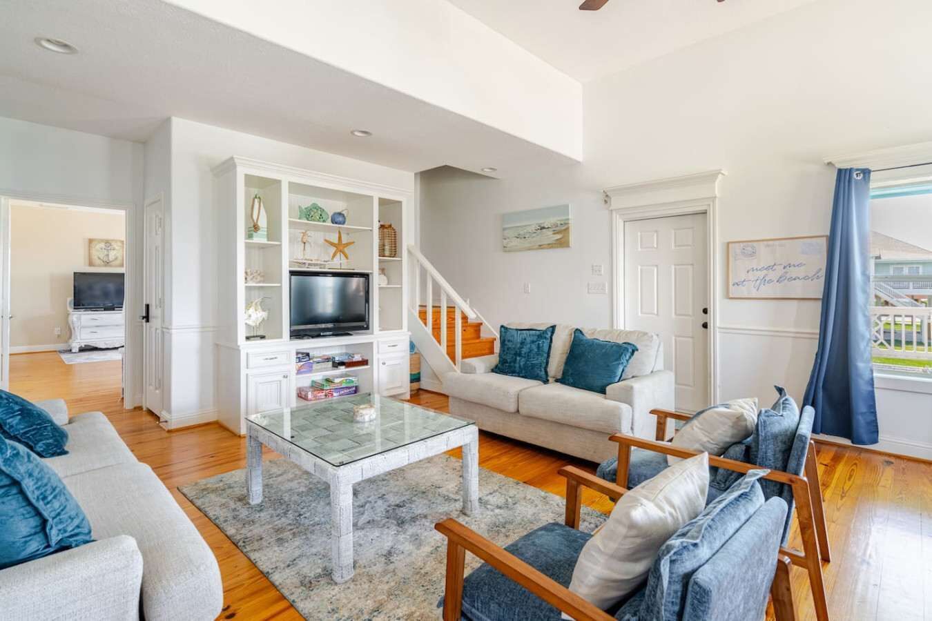 A living room with a TV, sofa, and coffee table.