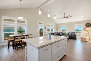 A spacious living area with a kitchen island, dining table, and seating. - 3 Bd 2 5 Bth, King Bed, Pet Friendly (Bolivar Peninsula)