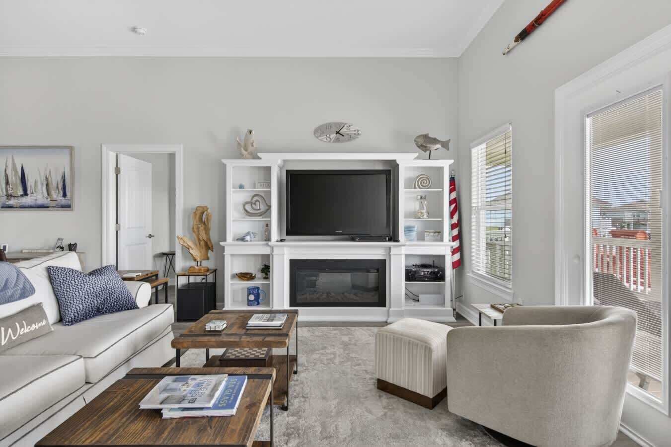 A living room with a fireplace, a television, and a sofa.