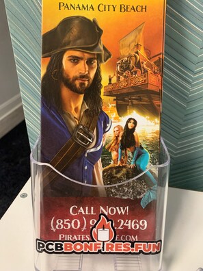 Ein Werbeposter für Panama City Beach im Piratenstil, mit einem Schiff und einem Aufruf zur Besichtigung einer Webseite.