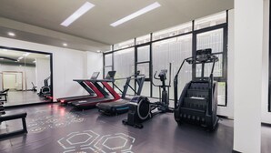 Ett gym med löpband, crosstrainers och en roddmaskin.