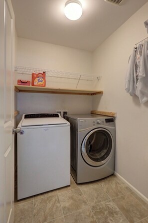 A compact laundry room with a washing machine and a refrigerator. - Peaceful Bothell Home 3B2.5B for Extended Stay (Bothell)