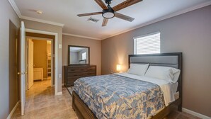 A bedroom with a bed, a ceiling fan, a dresser, a mirror, and a window. - 3-bedroom house in tranquil Naples with cool AC comfort (Naples)