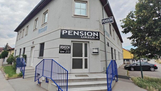 A two-story building with a sign reading 'PENSION URSULA' and a contact number. - Pension Ursula (Pfaffstätten)
