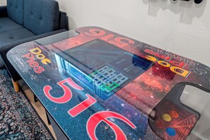A gaming table with a space-themed design, including a large number '516' and various game titles. - BRAND NEW! Tall Timbers Modern Cabin w/ Hot Tub (Hollister)
