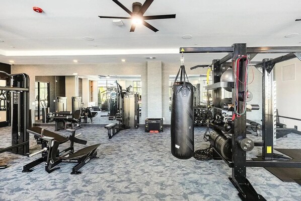 A gym with various exercise equipment, including a punching bag, weight machines, and free weights. - Modern Emerald Oasis 
Stylish Decatur Getaway (Decatur)