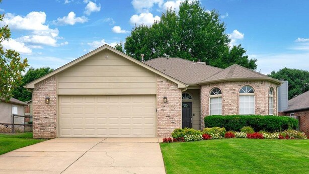A single-story house with a garage, a brick facade, and a well-maintained lawn. - Casa Joya @ Jenks Spain Ranch/Five Oaks (Jenks)