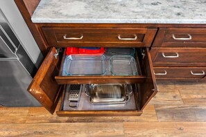 A kitchen drawer with multiple compartments, including a spice rack and a utensil holder. - Casa Joya @ Jenks Spain Ranch/Five Oaks (Jenks)