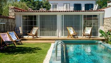 Piscine extérieure, parasols de plage, chaises longues