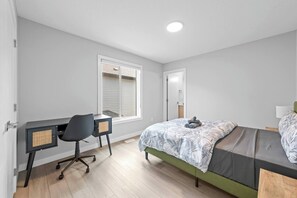 Une chambre à coucher avec un lit, un bureau et une chaise.