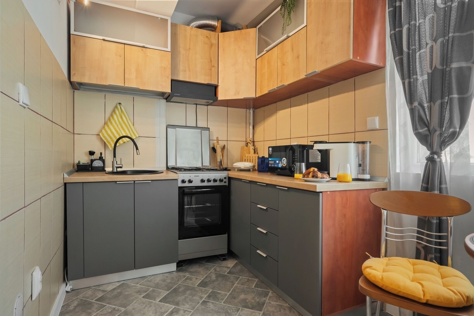 Una cocina compacta con estufa, horno y electrodomésticos modernos.