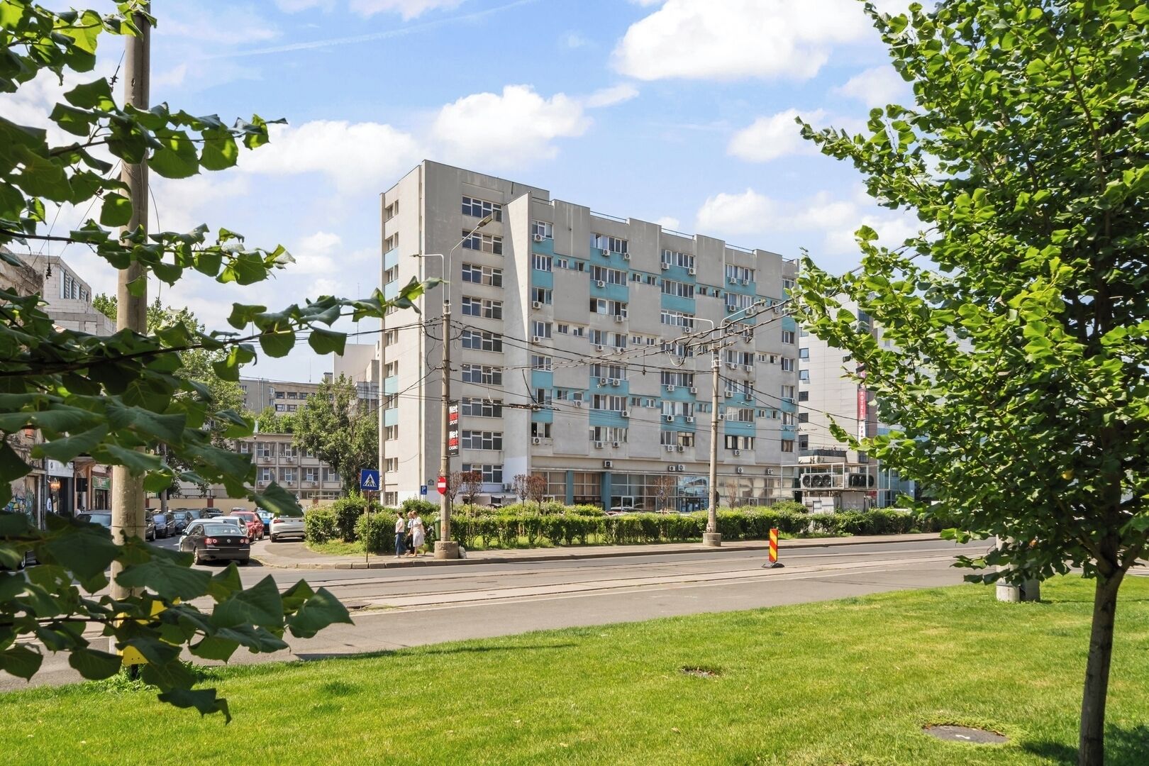 A multi-story building with a flat facade, several windows, and a visible entrance.