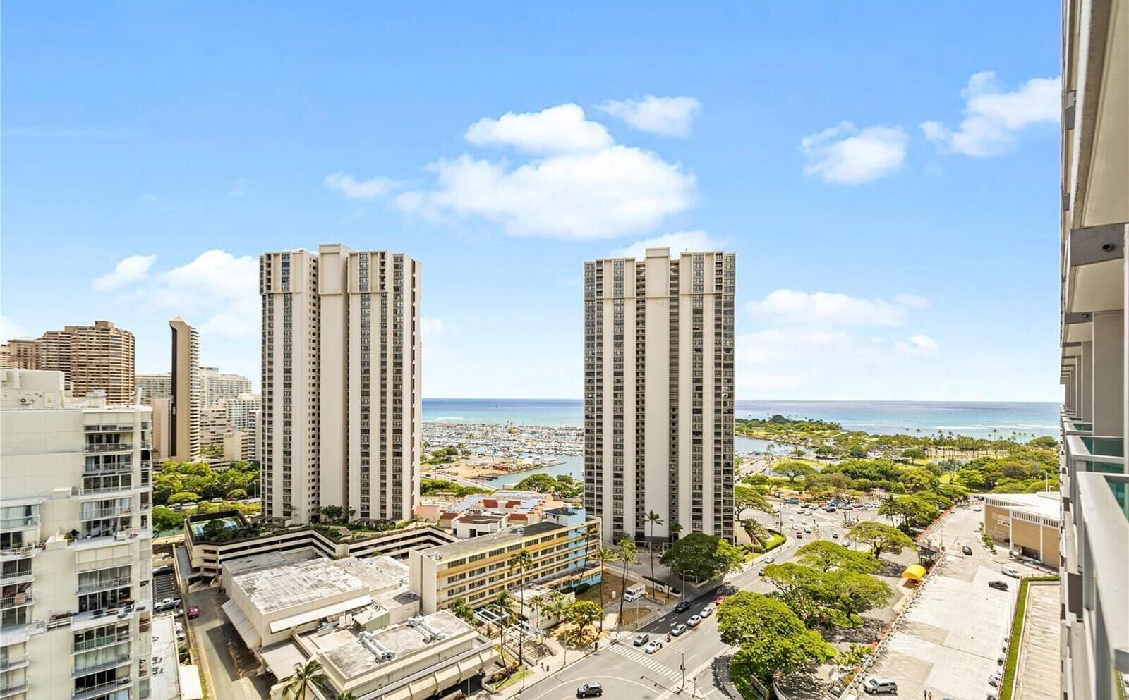 A high-rise building with a view of the ocean and a cityscape.