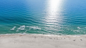 A beach with clear turquoise water and a sandy shore. - Fall Deals + Snowbird Rates | Gulf Front Beach Escape (Panama City Beach)