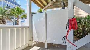 A covered outdoor area with a pool heater, a red hose, and a 'POOL RULES' sign. - Spacious 7-bedroom Beach House in fantastic Ocean Isle Beach w/ Private Pool&AC (Ocean Isle Beach)