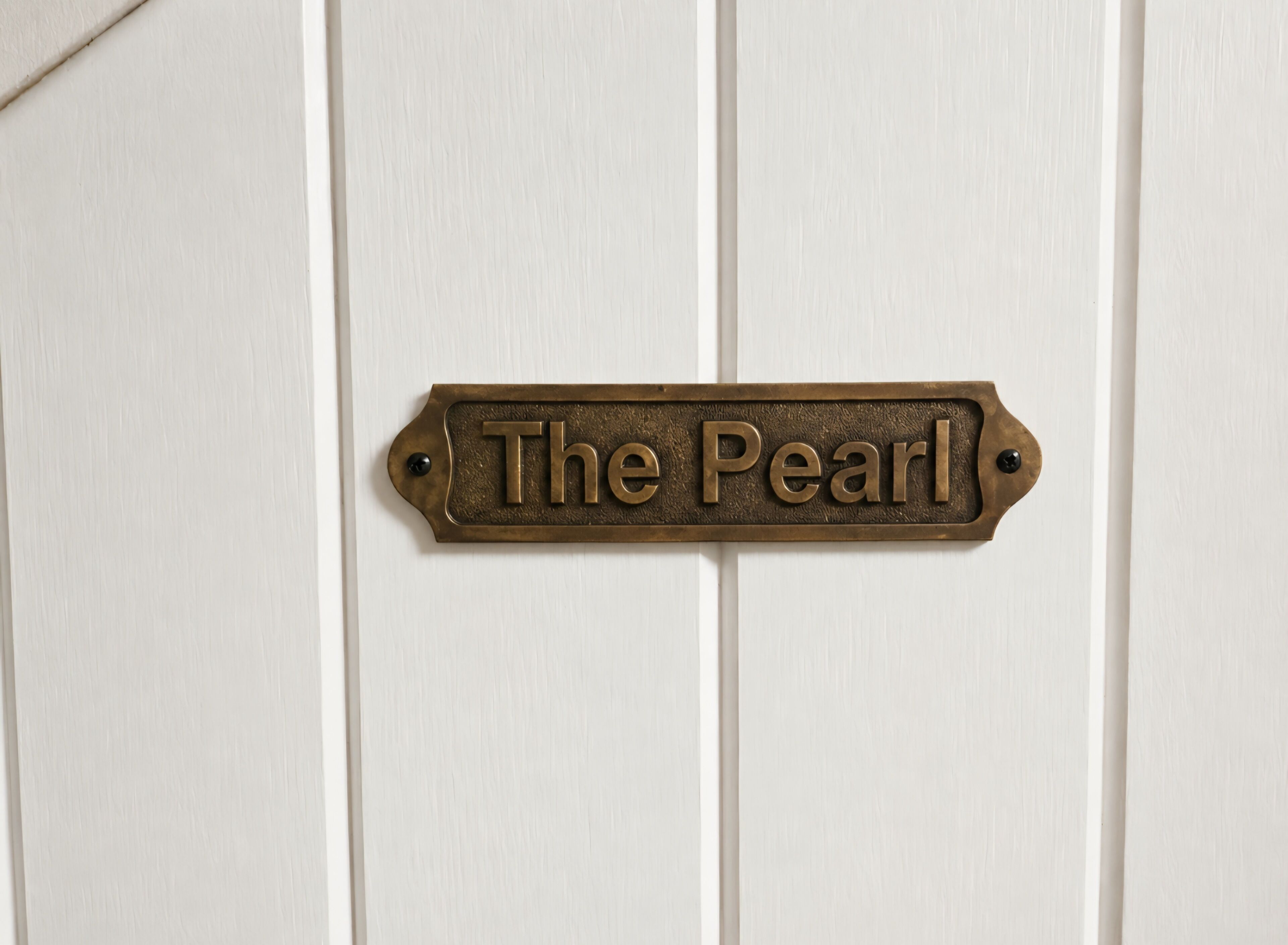 A door with a brass nameplate that reads 'The Pearl.'