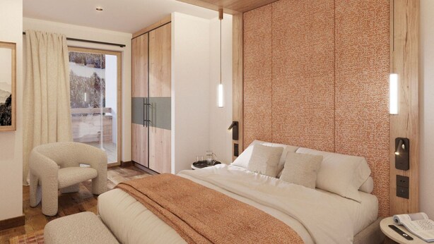 A hotel room with a bed, a chair, a bedside table, and a view of the outside. - Ski-in/ski-out apartment at Rond-Point des Pistes (Méribel)