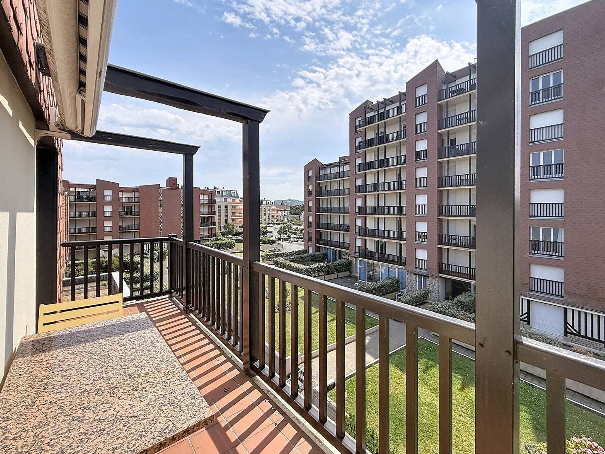 A balcony with a view of a residential building complex.