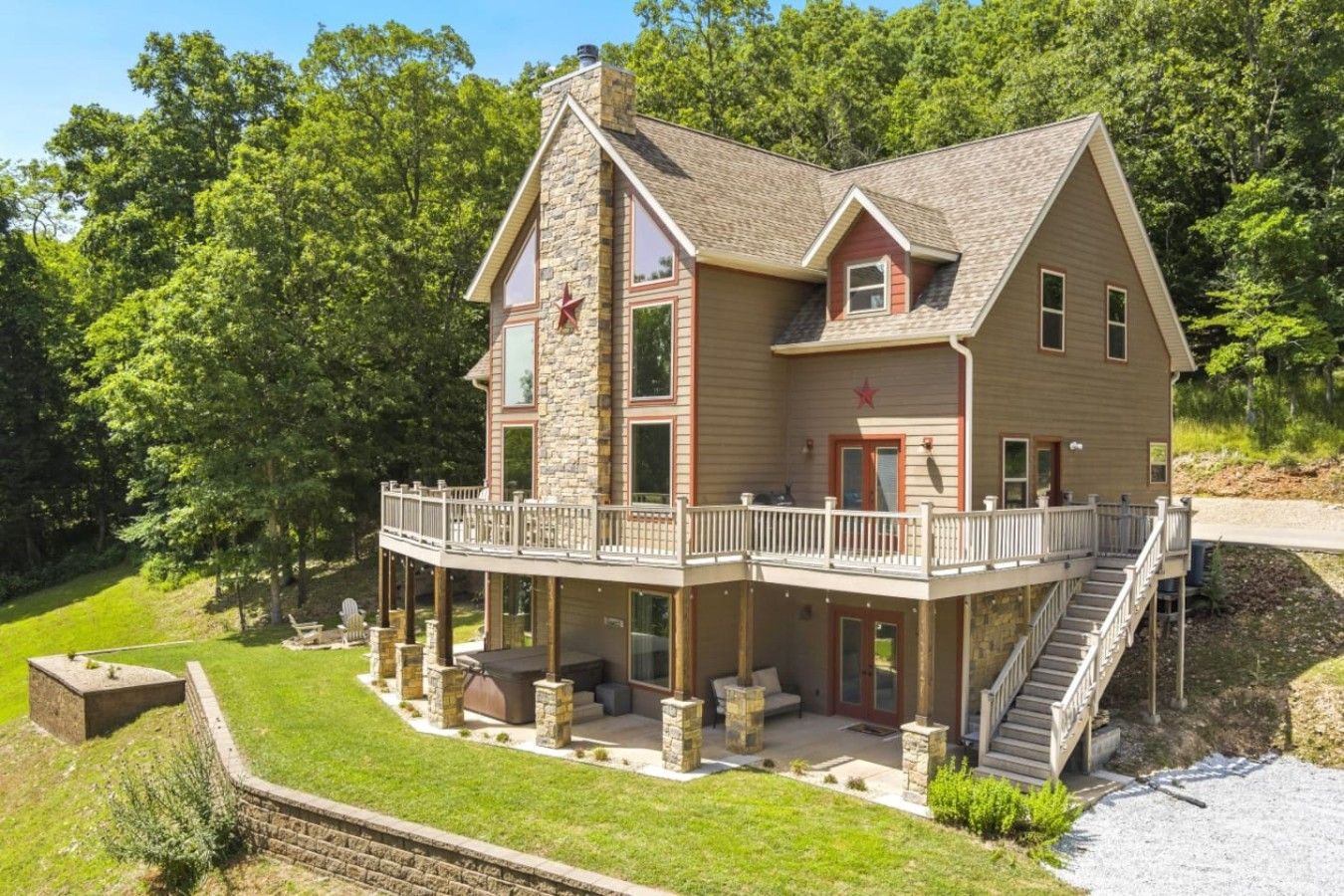 A two-story house with a balcony and a stone chimney.