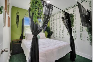 A bedroom with a canopy bed, green walls, and hanging plants. - MiamiMuralHouse:4BRw/Themes, Gameroom, Backyard (Miami)