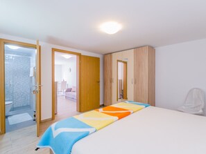 A bedroom with a bed, a wardrobe, a shower area, and a door leading to a bathroom. - Leng 1 / HR-10352-01 by Interhome (Crikvenica/Dramalj)