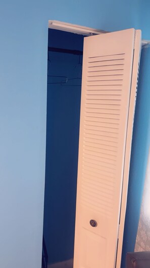 A closed white door with horizontal slats, a visible handle, and a keyhole. - Cozy 1-bedroom studio in perfect Lauderdale Lakes with AC & Pool access (Lauderdale Lakes)