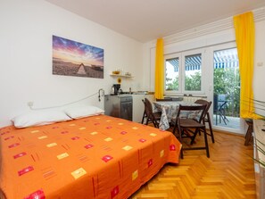A bedroom with a bed, a desk, and a window with curtains. - Azur 3 / HR-04335-03 by Interhome (Crikvenica/Dramalj)