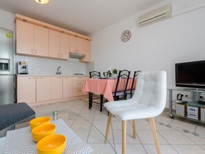 A modern apartment with a kitchen, dining area, and living space. - Omega Cert / HR-09851-01 by Interhome (Crikvenica)
