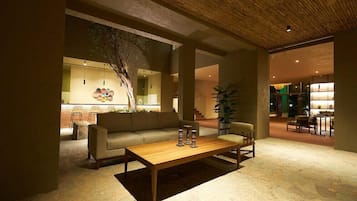 A modern interior with a wooden coffee table, a sofa, and a dining area.