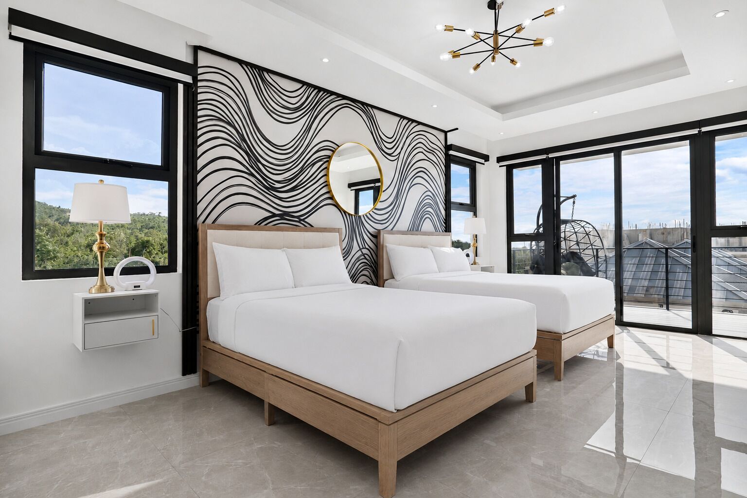 A modern bedroom with two beds, a large window, and a view of the cityscape.
