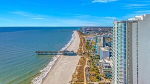 A coastal cityscape with a beach, a pier, and high-rise buildings. - Atlantica 200 Oceanfront Condo (Myrtle Beach)