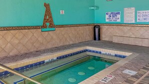 A swimming pool with a tiled edge, a lifeguard sign, and a no diving warning sign. - Atlantica 200 Oceanfront Condo (Myrtle Beach)
