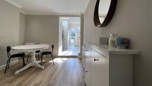 A modern interior with a dining area, a vanity with a mirror, and a view to the outside. - Full House - Croydon Centre (Croydon)