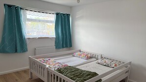 A room with a white crib, a window with teal curtains, and a radiator. - Ivy Veil
A home away from home (Witham)