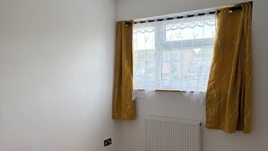 A room with a window, white walls, a radiator, and a light fixture. - Ivy Veil
A home away from home (Witham)