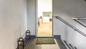 A staircase leading to a bright room with a kitchen in the background. - Bonbeach Retreat by Ready Set Stay - 2 Bedroom, Family Friendly Apartment (Bonbeach)