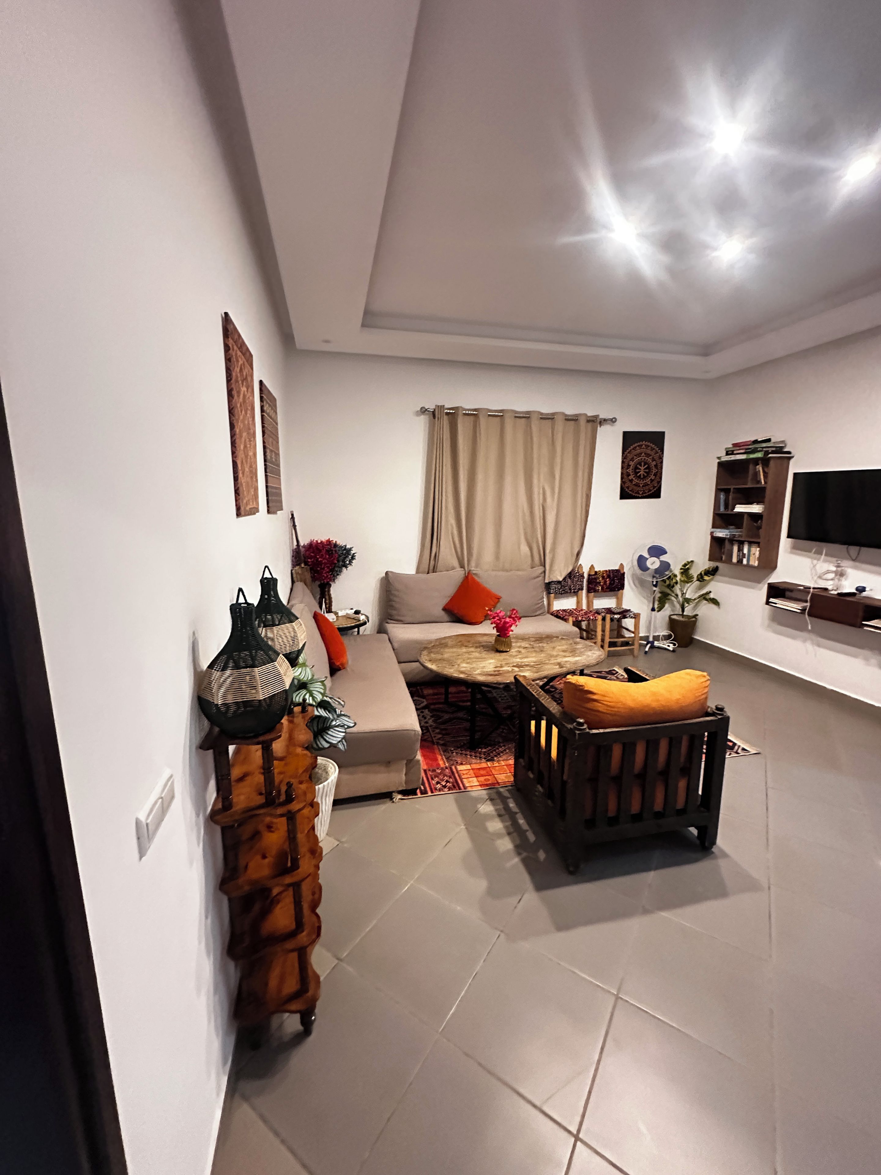 A modern living room with a sofa, coffee table, and a television.