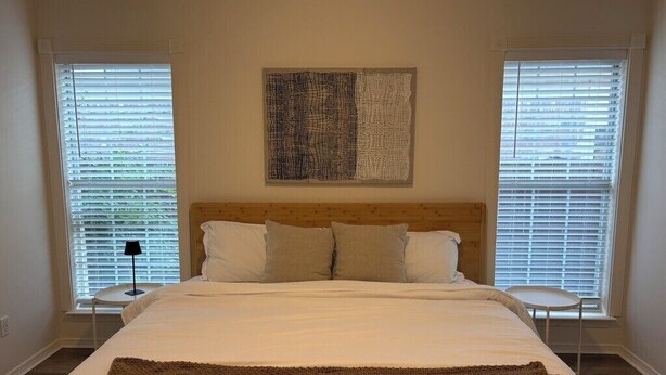 A bedroom with a large bed, two bedside tables, and a headboard. - Spacious 3BR House in Frisco - Minutes from Top Event Attractions (Frisco)