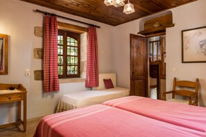 A room with two beds, a wooden desk, a window with curtains, and a wooden door. - Kamares secluded villa with private pool (Macheri)
