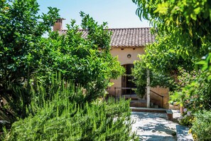 A building with a tiled roof, surrounded by lush greenery. - Kamares secluded villa with private pool (Macheri)