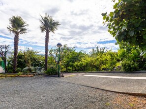 A paved pathway, palm trees, and a street lamp in a landscaped area. - Apartment Duema by Interhome (Opatija/Pobri)