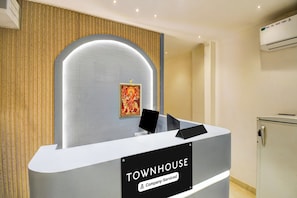A reception desk with a sign reading 'TOWNHOUSE Company-Serviced.'